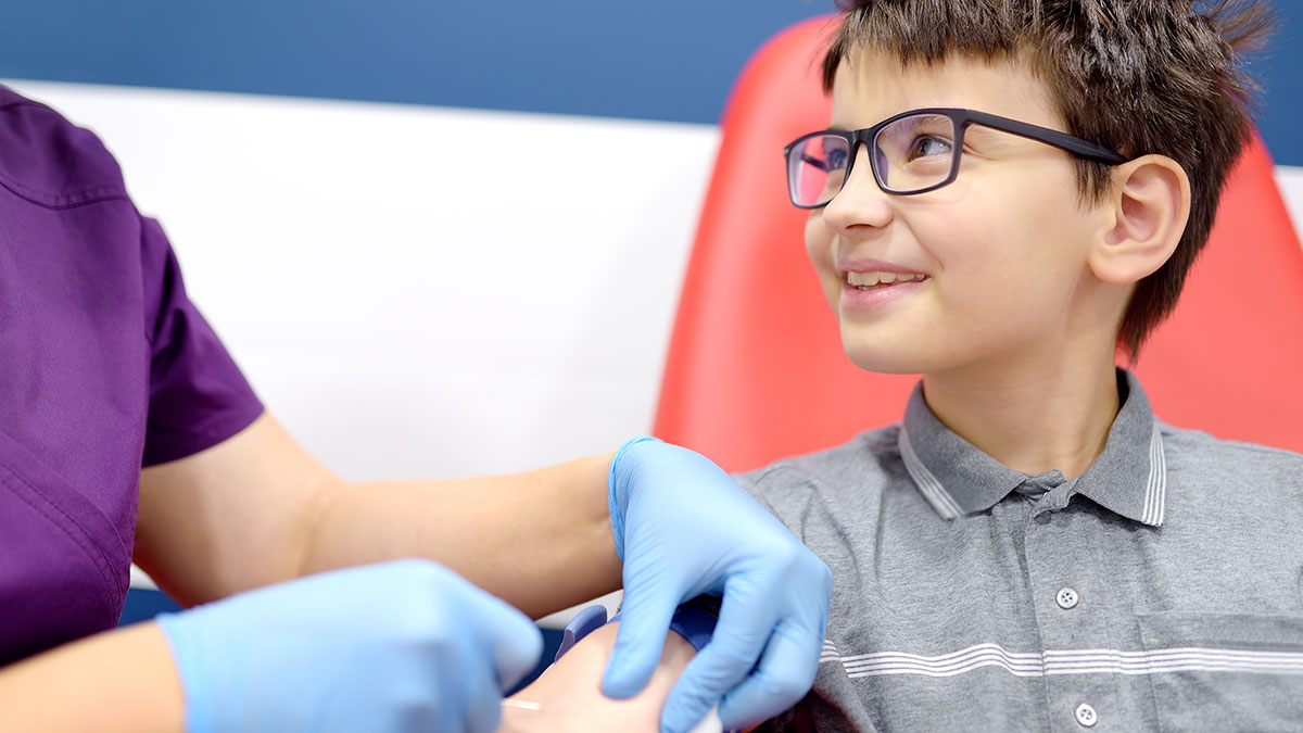 Smiling young boy getting an injection