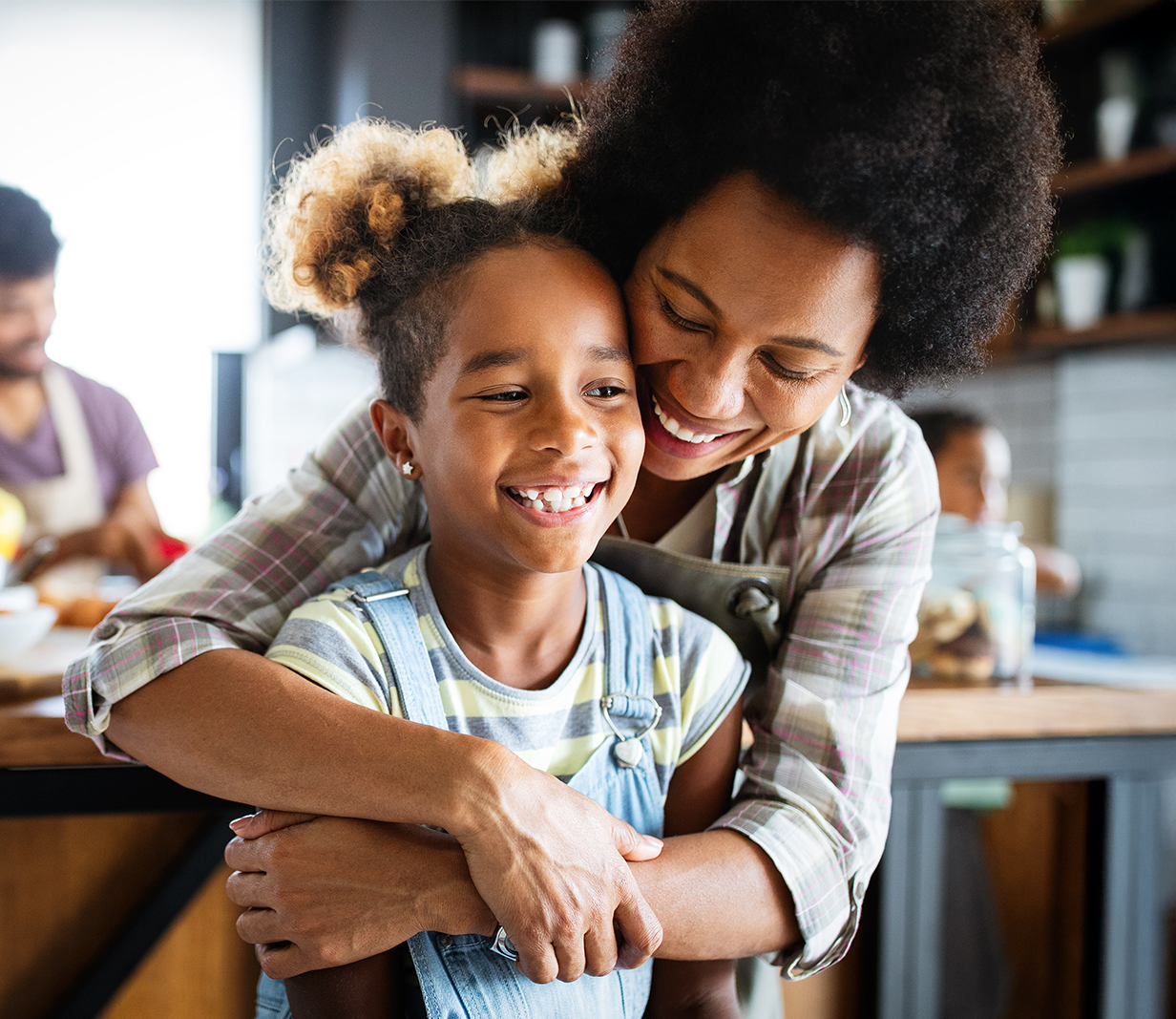 An elderly couple holding hands and looking lovingly at each other as they enjoy their lunch